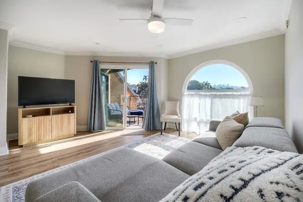 a bedroom with furniture and a flat screen tv