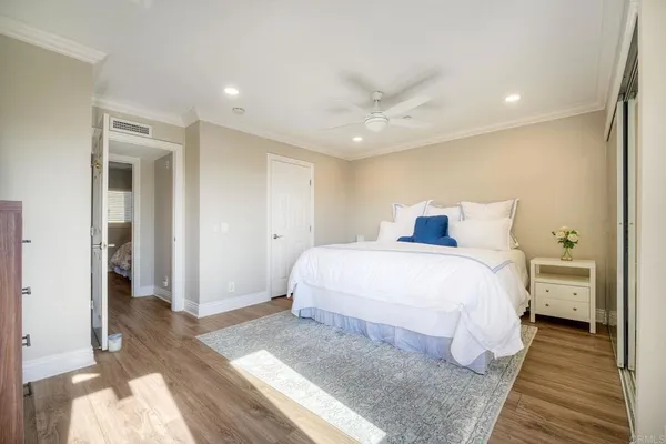 a spacious bedroom with a bed and a view of bedroom
