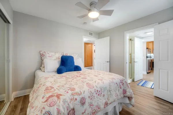 a bedroom with a bed and a chandelier
