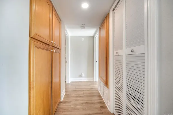 a view of a hallway with wooden floor and staircase