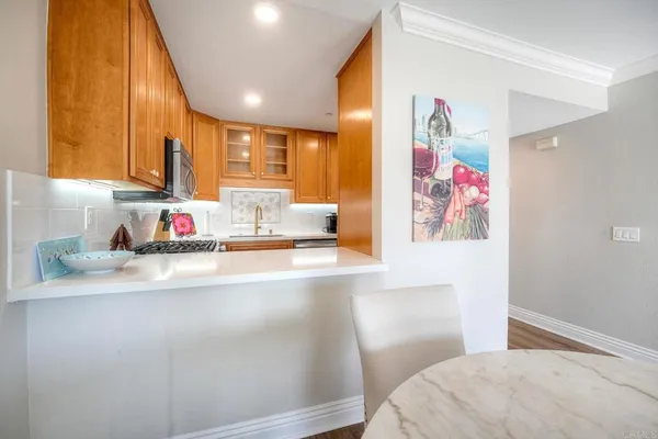 a bedroom with a bed and a kitchen with sink