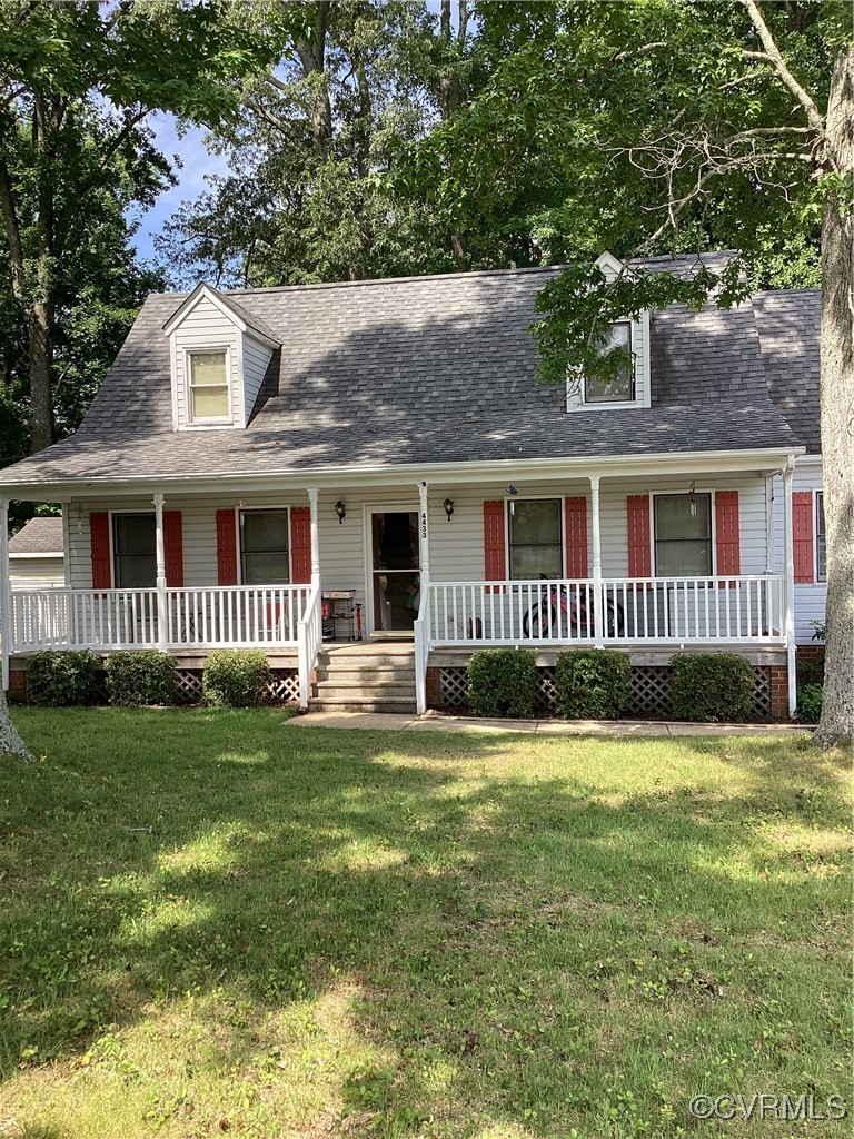 Cape cod-style house with a porch, a front yard, a