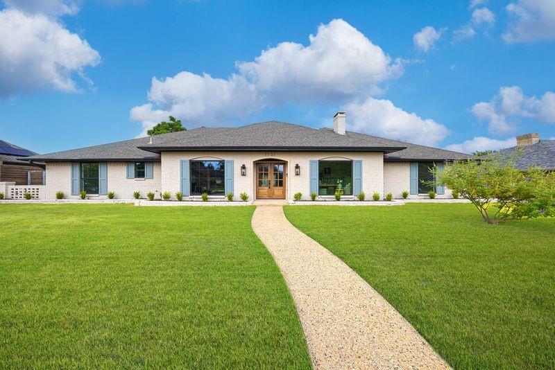 a view of house that has a yard