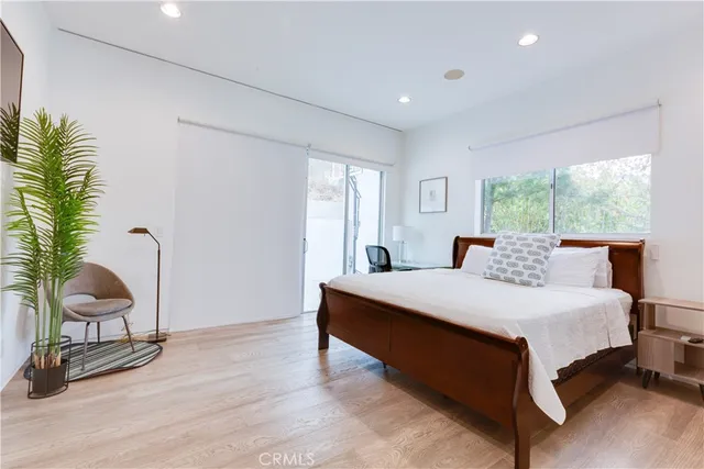 a bed room with a bed and chair