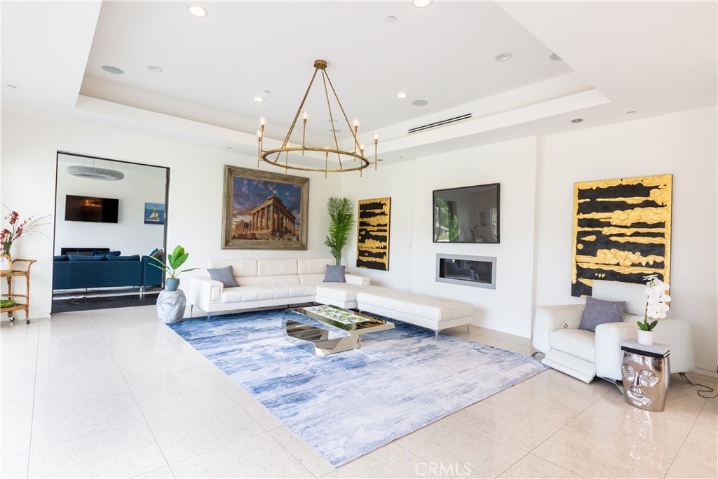 12148 Travis Street Los Angeles, CA 90049 - Photo 20 of 32 a living room with furniture and a chandelier