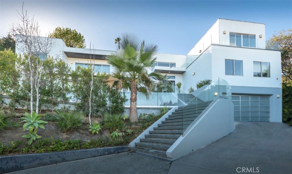 12148 Travis Street Los Angeles, CA 90049 - Photo 2 of 32 a view of a house with a yard