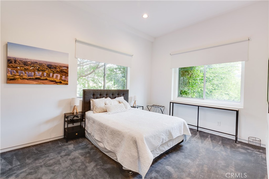 12148 Travis Street Los Angeles, CA 90049 - Photo 23 of 32 a bedroom with a bed and a window