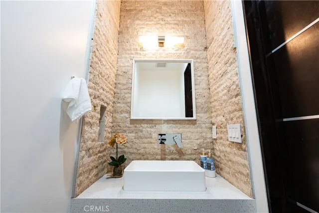 a bathroom with a sink a mirror and a shower