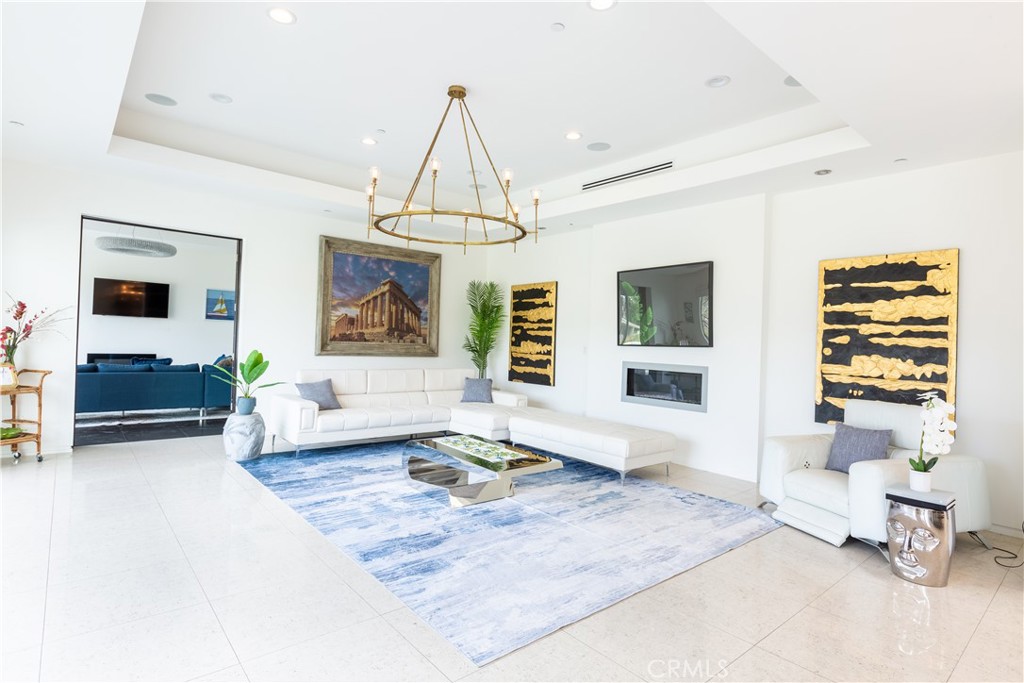 12148 Travis Street Los Angeles, CA 90049 - Photo 27 of 32 a living room with furniture and a chandelier