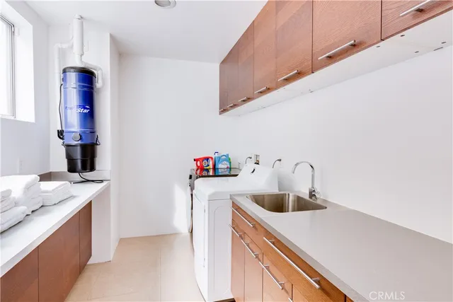 a kitchen with a sink a stove and cabinets