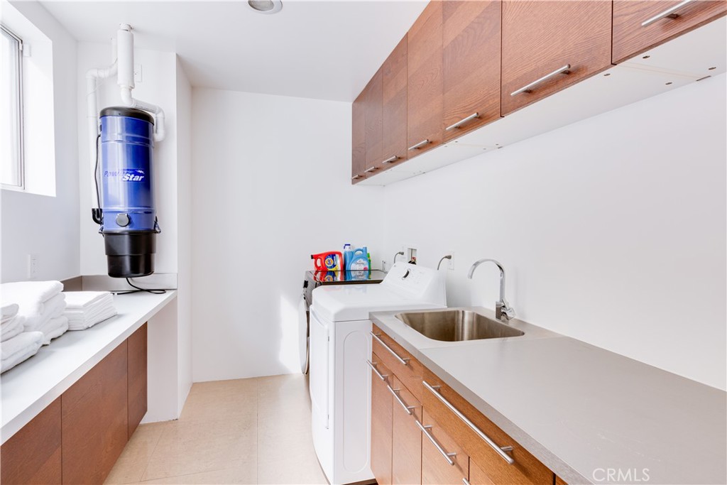 12148 Travis Street Los Angeles, CA 90049 - Photo 28 of 32 a kitchen with a sink a stove and cabinets