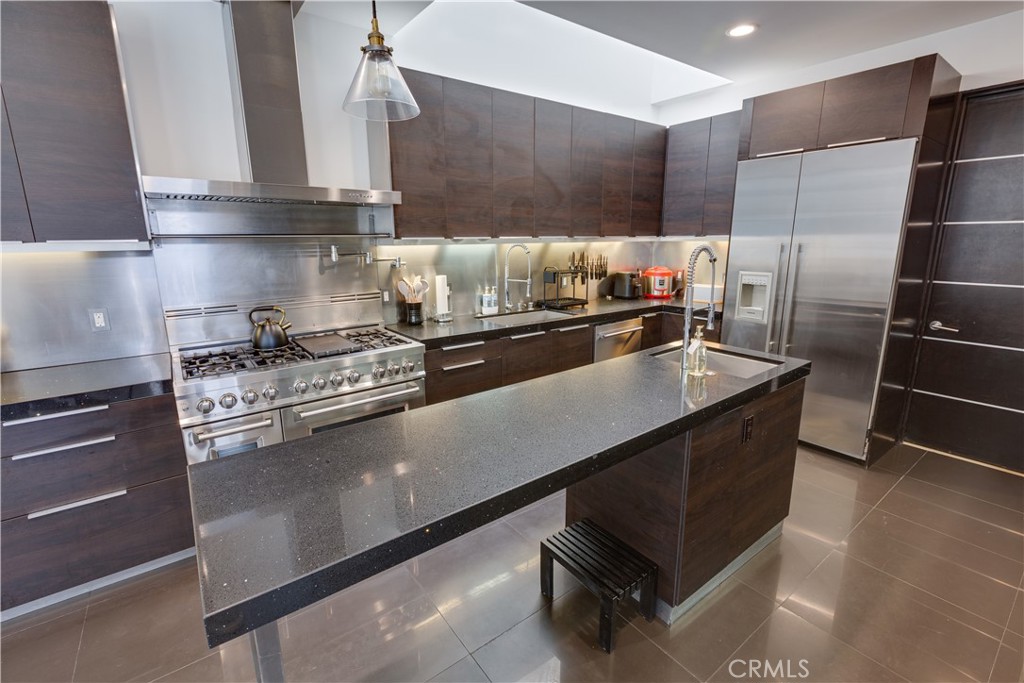 12148 Travis Street Los Angeles, CA 90049 - Photo 29 of 32 a kitchen with appliances cabinets and a counter top space