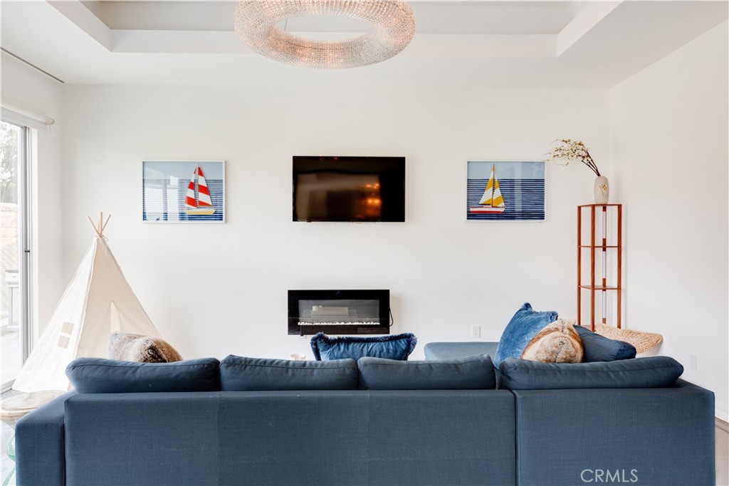 12148 Travis Street Los Angeles, CA 90049 - Photo 30 of 32 a living room with furniture and a flat screen tv
