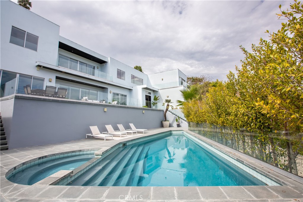 12148 Travis Street Los Angeles, CA 90049 - Photo 3 of 32 a view of a swimming pool with a balcony