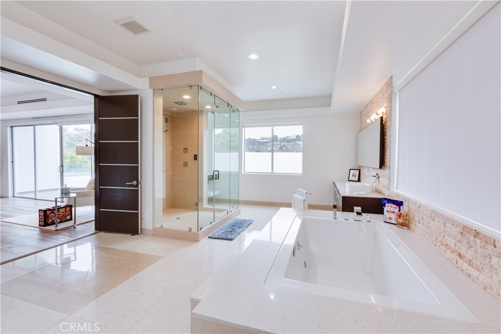 12148 Travis Street Los Angeles, CA 90049 - Photo 31 of 32 a large bedroom with a bed and large windows