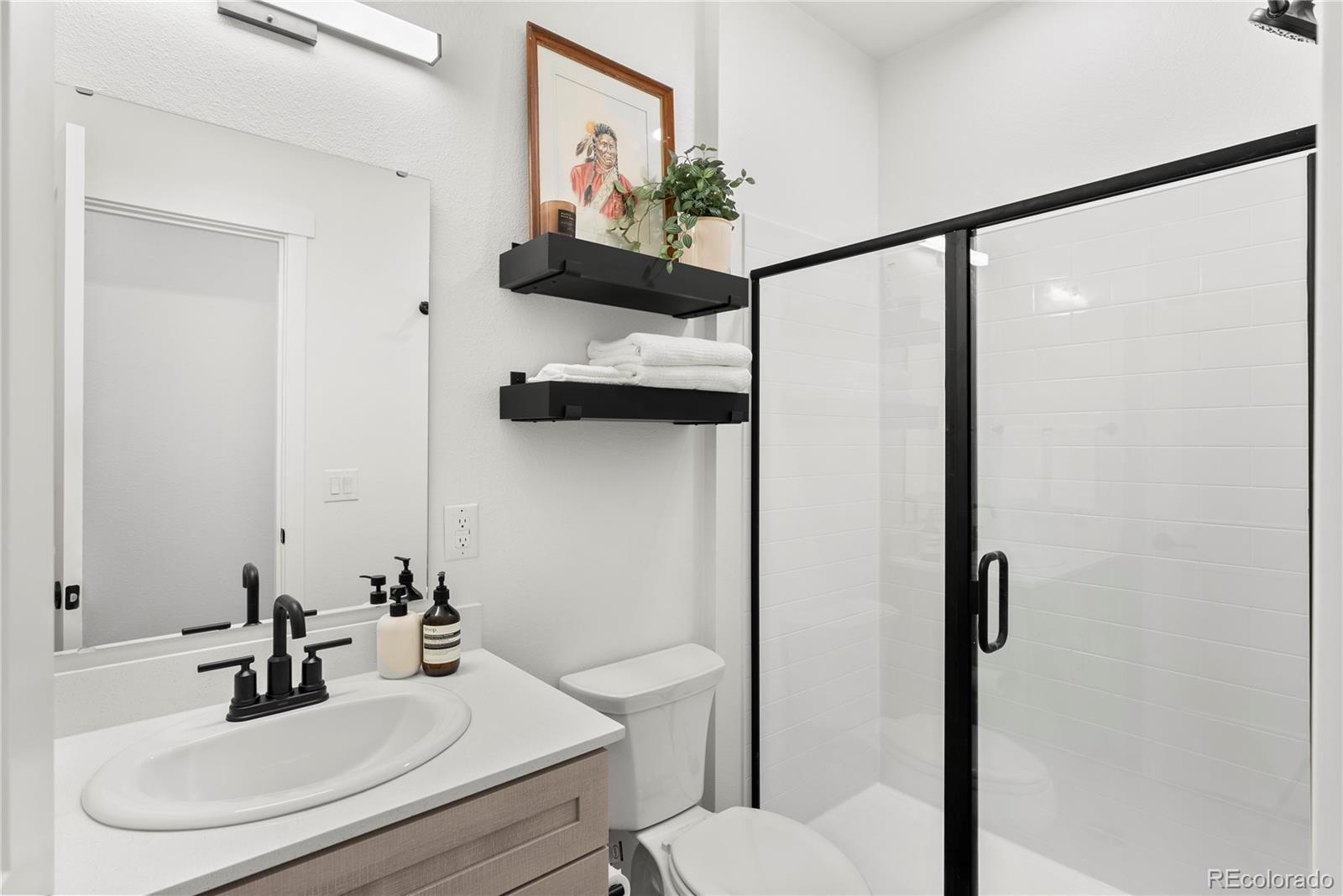 2121 Hummingbird Way, Unit 204 Georgetown, CO 80444 - Photo 22 of 36 a bathroom with a sink toilet and mirror