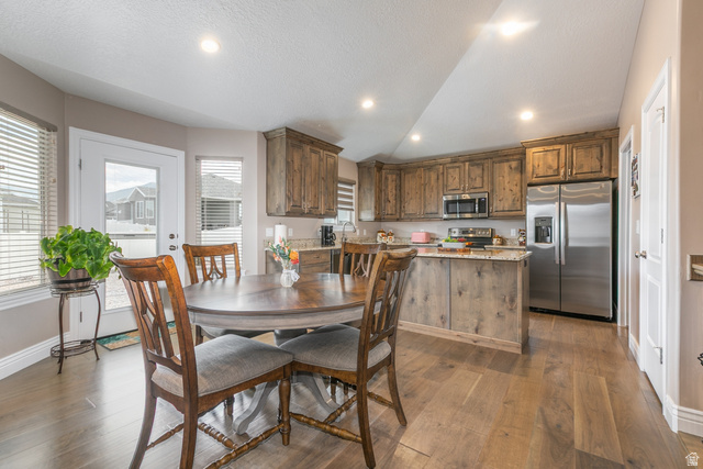 1228 North Providence Way Tooele, UT 84074 - Photo 6 of 28 Kitchen featuring wood-finish cabinetry, stainless steel appliances, granite countertops, and recessed lighting