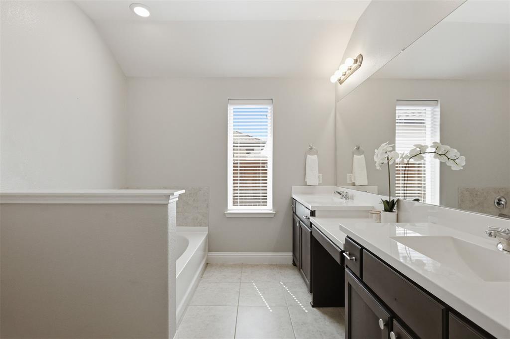 717 Allbright Road Celina, TX 75009 - Photo 18 of 37 Garden tub, dual sinks, linen closet. Separate walk in shower