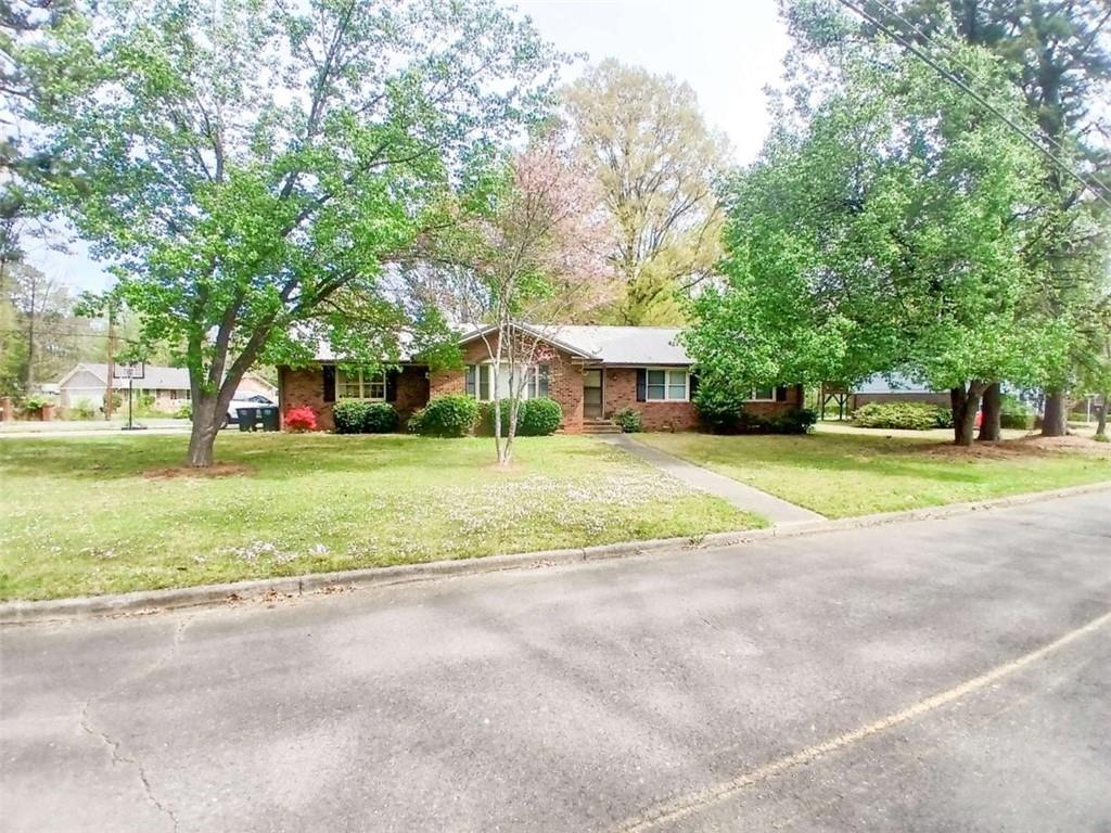 2 Castlewood Drive Southwest Rome, GA 30165 - Photo 1 of 1 a view of a house with a big yard and large trees