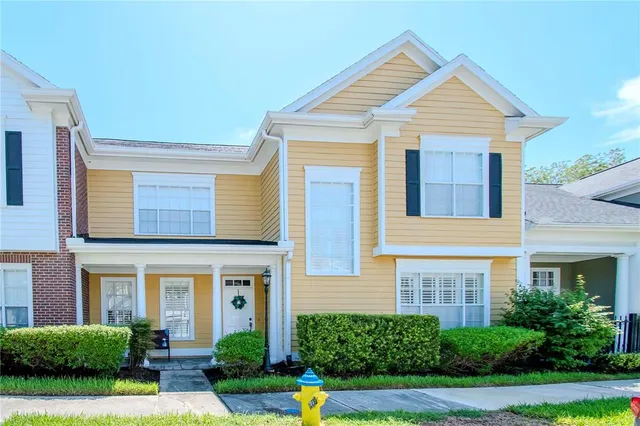 a front view of a house with yard and porch