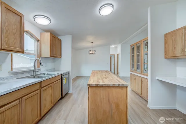 a kitchen with stainless steel appliances granite countertop a sink stove and cabinets
