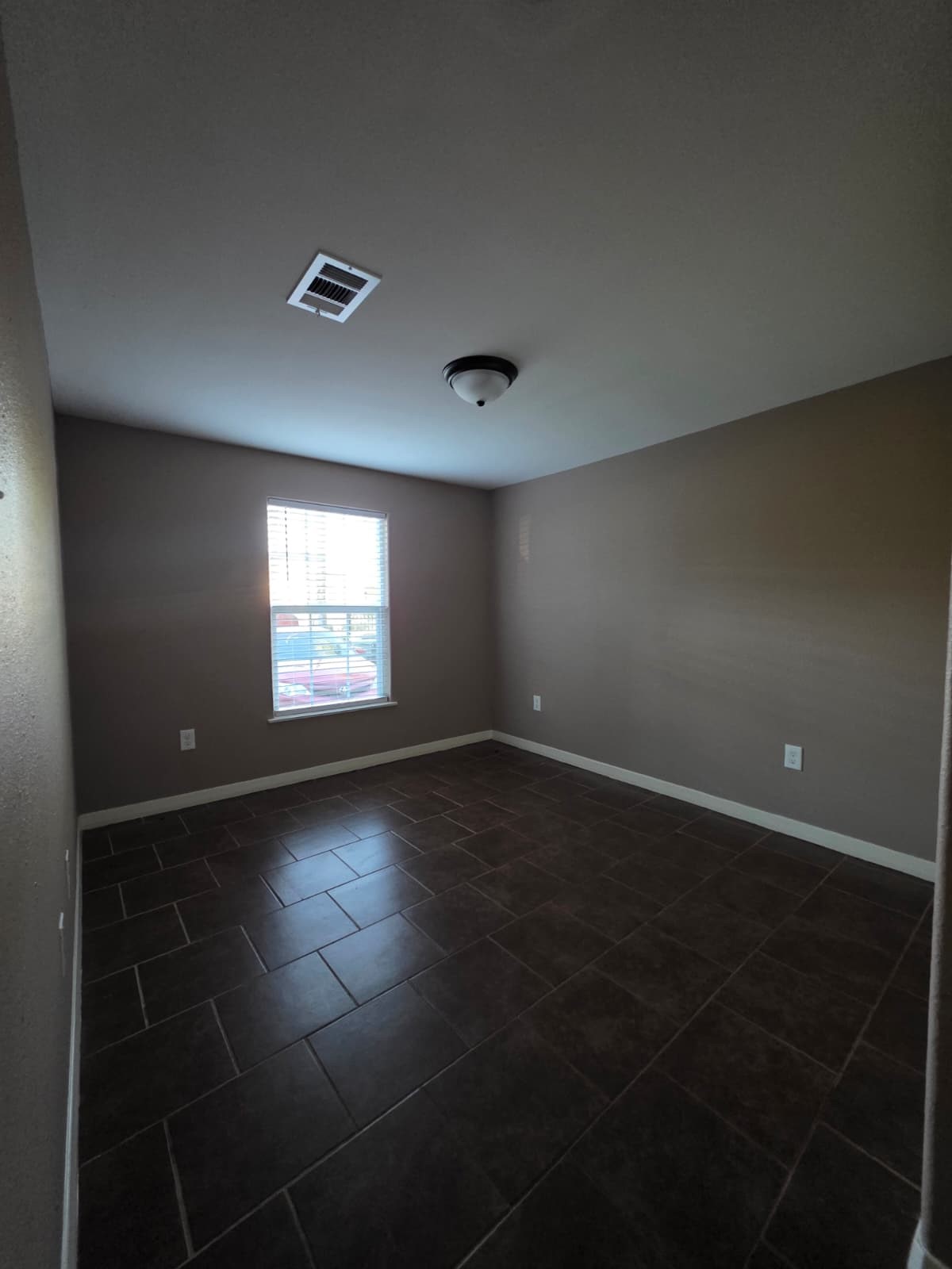 1720 Roxella Street Houston, TX 77093 - Photo 9 of 13 an empty room with wooden floor and windows