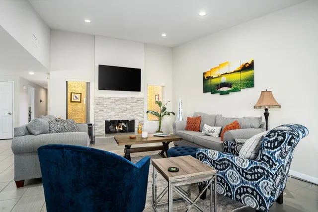 a living room with fireplace furniture and a flat screen tv