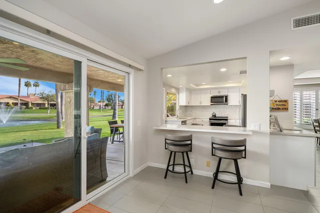 a kitchen with a table and chairs in it