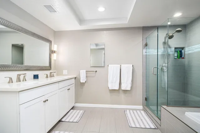 a bathroom with a shower sink and mirror
