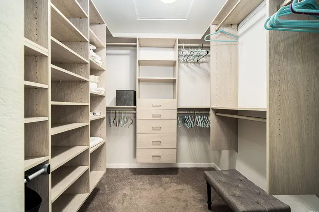 a view of walk in closet with empty racks