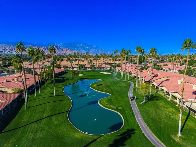 an aerial view of a golf course with parking space
