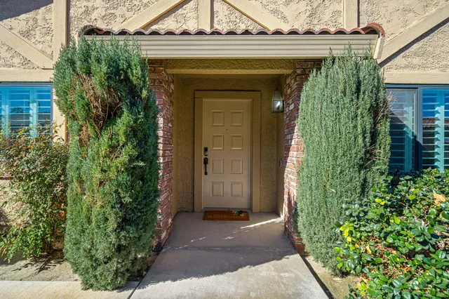 front view of a house with potted plants