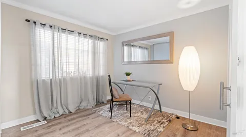 a living room with furniture a window and a chandelier