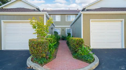 a view of a house with potted plants
