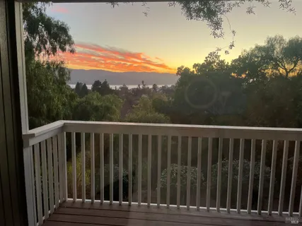 a view of balcony with wooden floor and fence