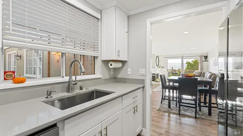 a kitchen with a sink cabinets and wooden floor