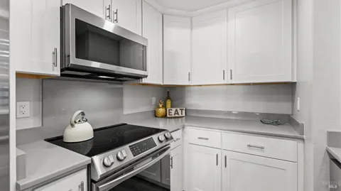 a kitchen with a stove and cabinets