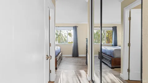 a view of a hallway with a livingroom and furniture
