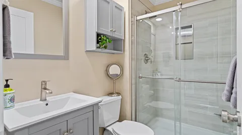 a bathroom with a sink toilet and shower
