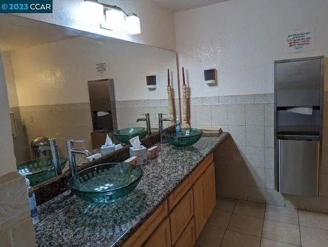 a kitchen with granite countertop a sink and a stove