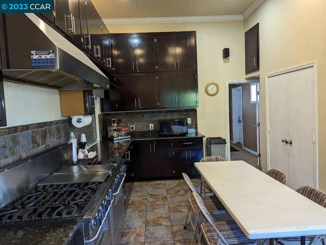 a kitchen with stainless steel appliances granite countertop a stove and a refrigerator