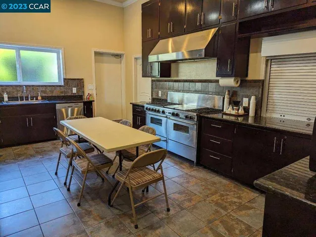 a kitchen with a table chairs and a stove