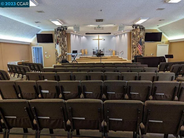 a large room with lots of chairs and a projector screen