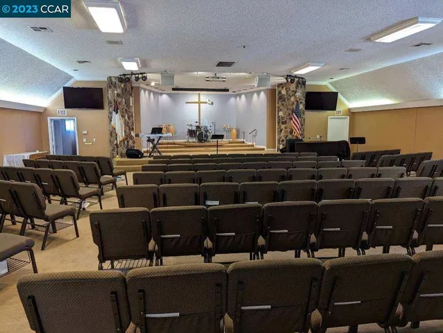 a room with lots of chairs and mirrors