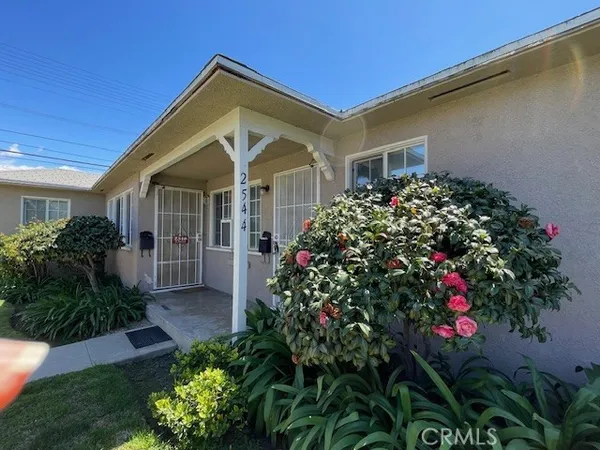 a front view of a house with a flower garden