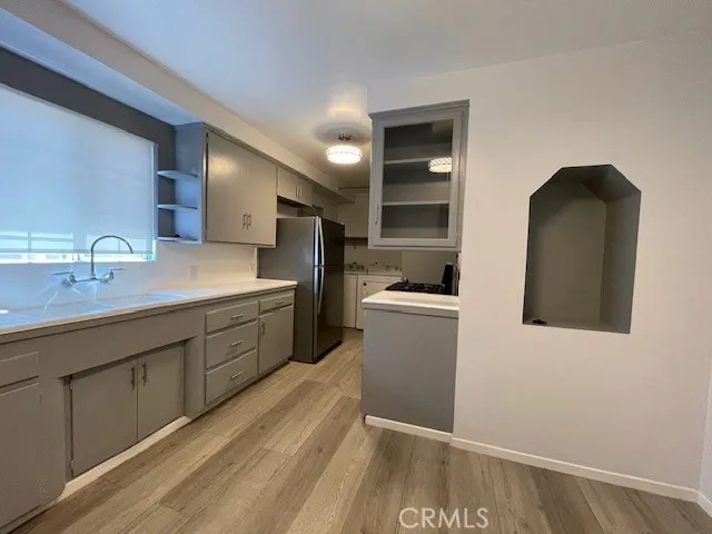 a kitchen with a sink and refrigerator