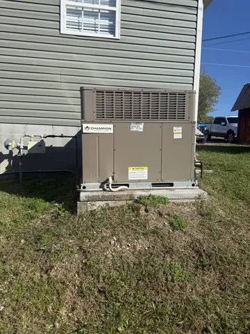a backyard of a house with dishwasher and wooden fence