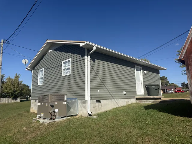 a backyard of a house with table and chairs