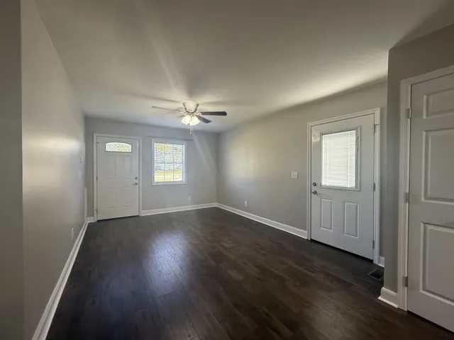 a kitchen with stainless steel appliances granite countertop a refrigerator a sink and wooden cabinets