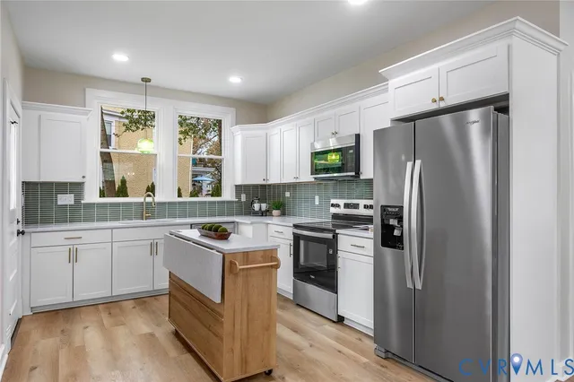 a kitchen with a sink stove and refrigerator